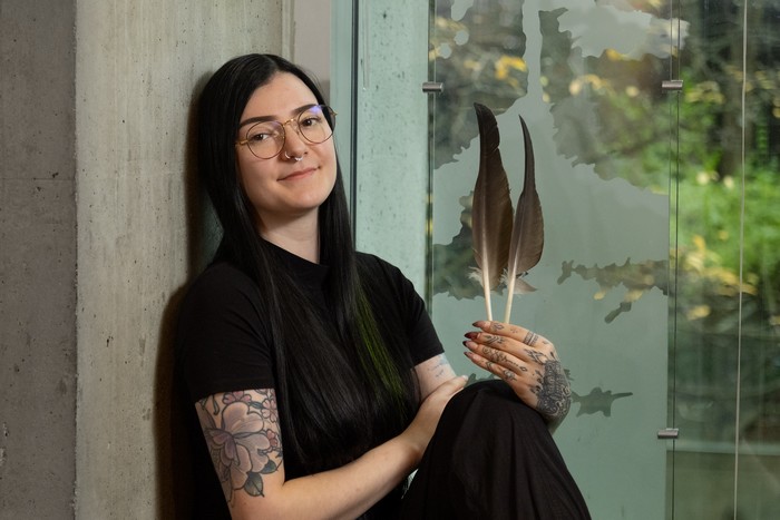 Isabelle (Izzy) Foy holding 2 feathers in her hand