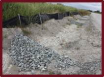A gravel check-dam in a drainage ditch with a silt fence.